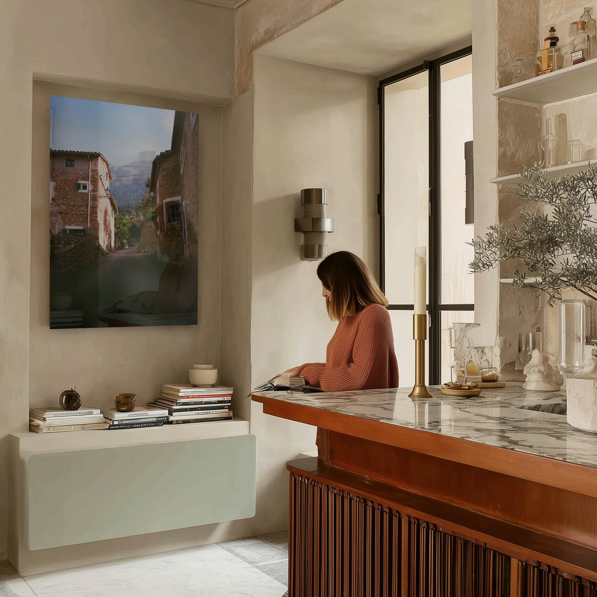 Il Vicolo above a travertine console in an entryway, dried branches in a stone vase