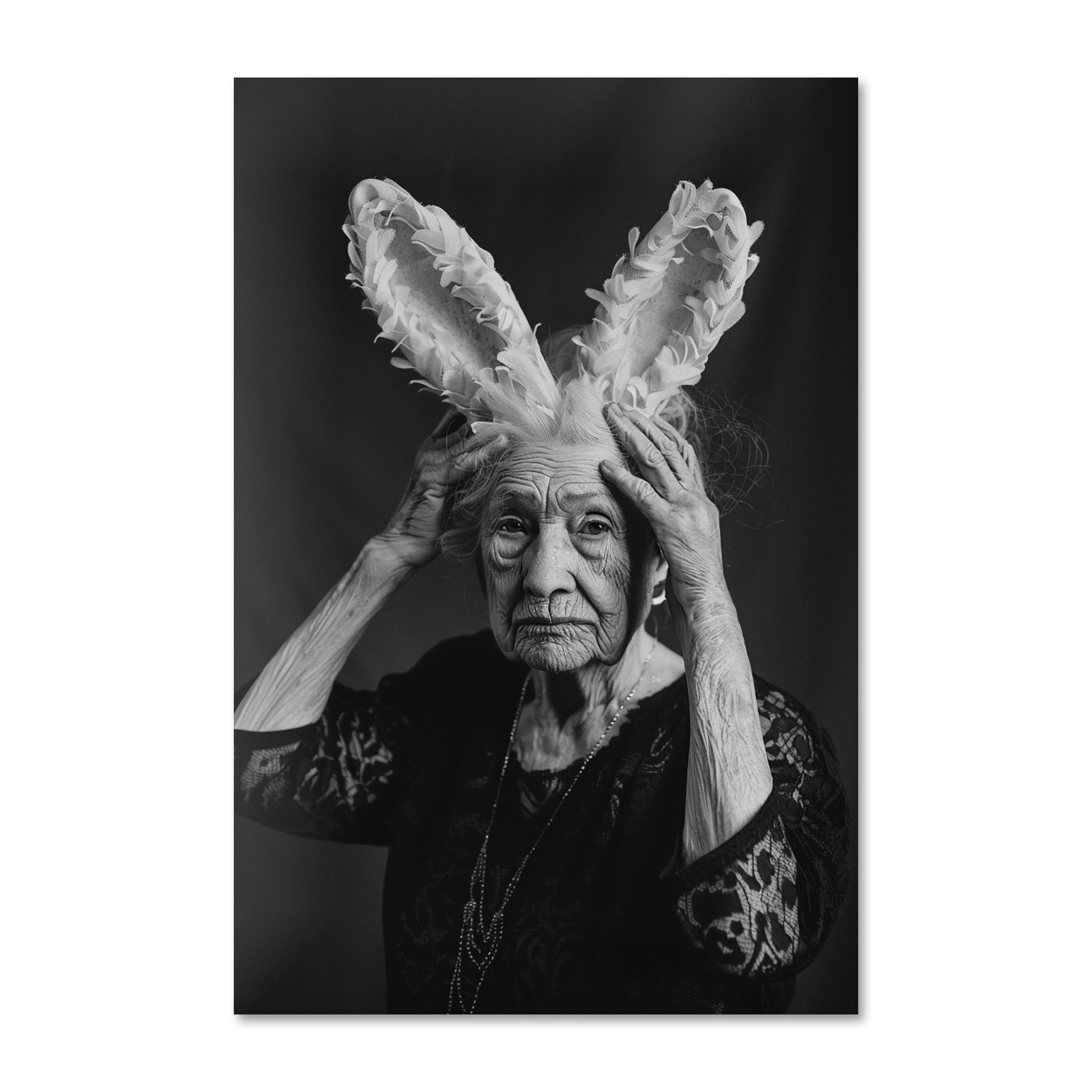 Elder's Whimsy 3 — black and white editorial portrait of an elder lifting fabric rabbit ears, on Alu-Dibond