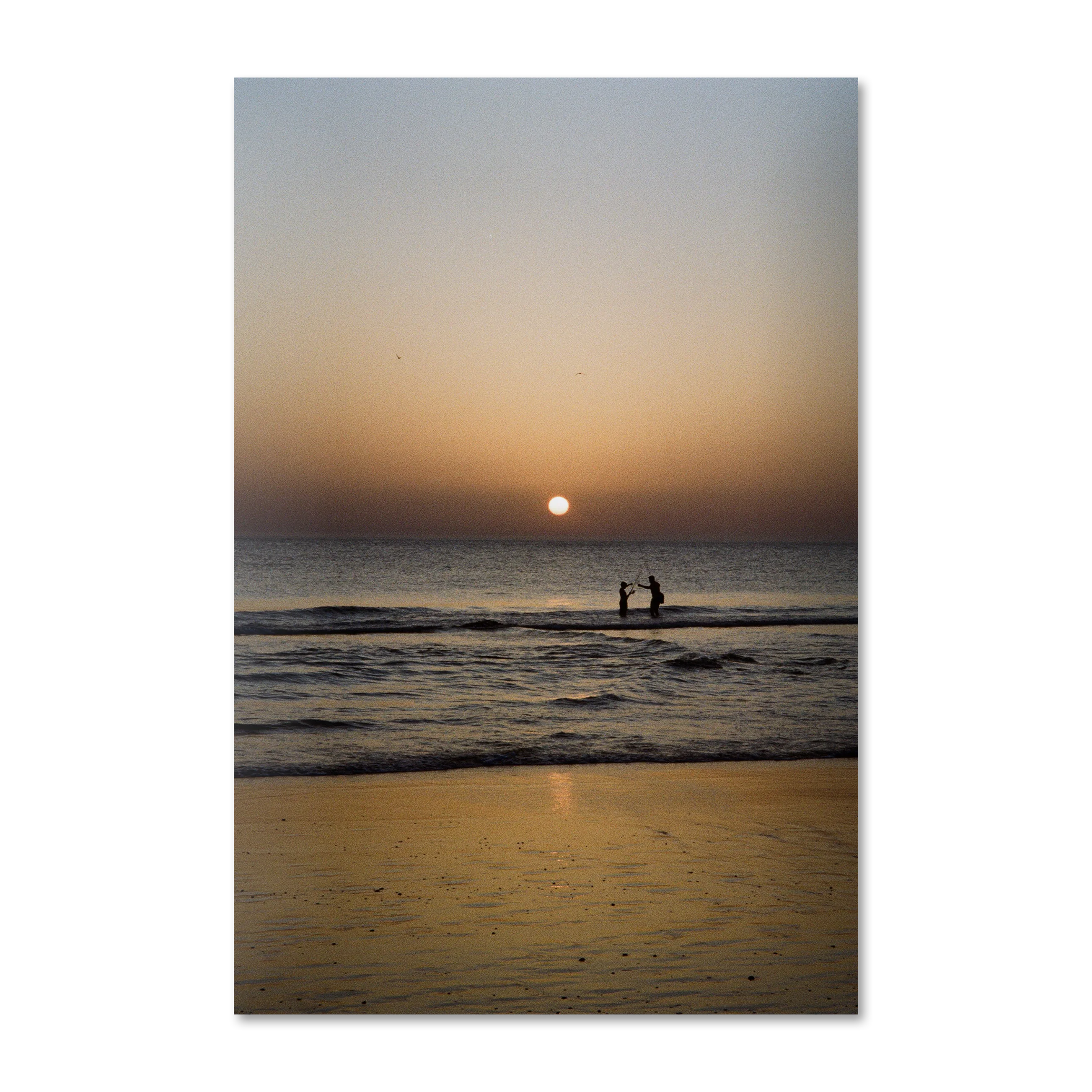 Mediterranean Golden Hour — sunset coast wall art on frameless Alu-Dibond, two figures fishing in the surf