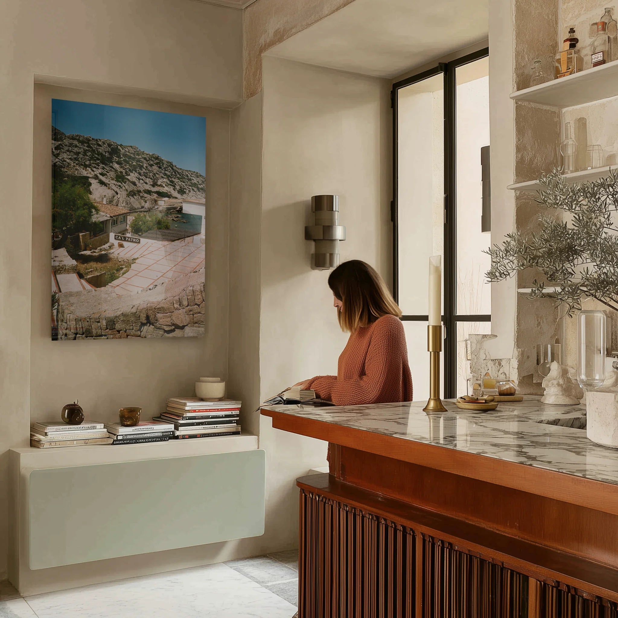 Silent Coast above a bouclé reading chair in a study lined with books