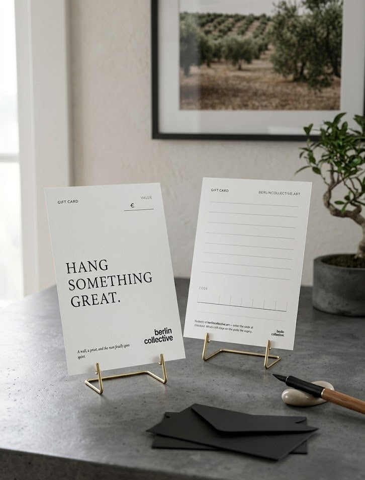 Berlin Collective Gift Voucher — printed card on brass easels, olive grove print in background